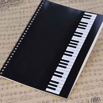 Sheet music and music theory notes in a study notebook